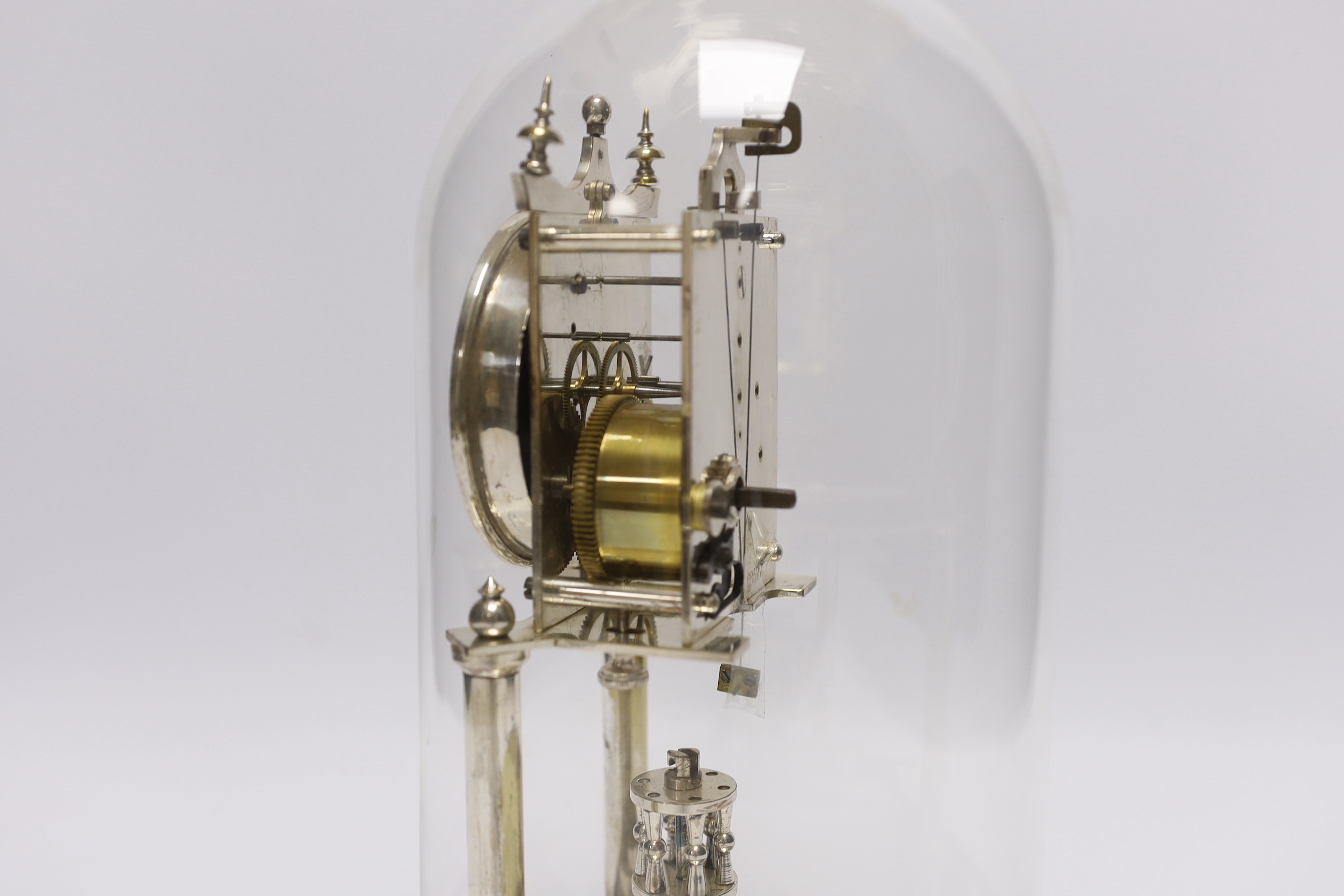 A chrome plated skeleton clock under dome, 29cm